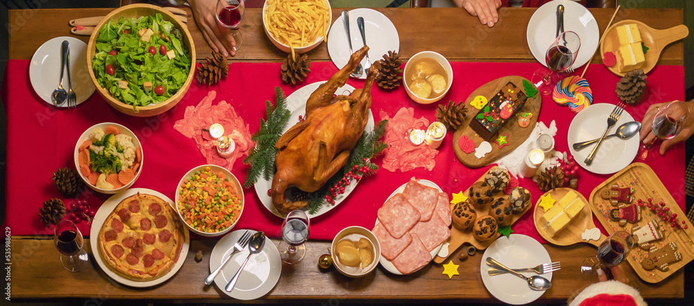 Christmas party food. A celebration dinner with a turkey, wine, champagne on Merry Christmas Eve Xmas on holiday at home. People lifestyle. Thanksgiving day Christmas party food. A celebration dinner with a turkey, wine, champagne on Merry Christmas Eve Xmas on holiday at home. People lifestyle. Thanksgiving day