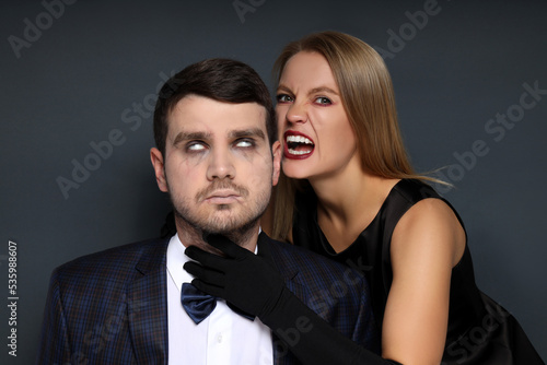 Concept of Halloween, young man and woman on dark background