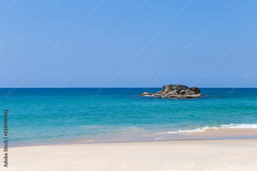 Tropical beach background, clean sandy beach with blue sea background, summer outdoor day light Tropical beach background, clean sandy beach with blue sea background, summer outdoor day light