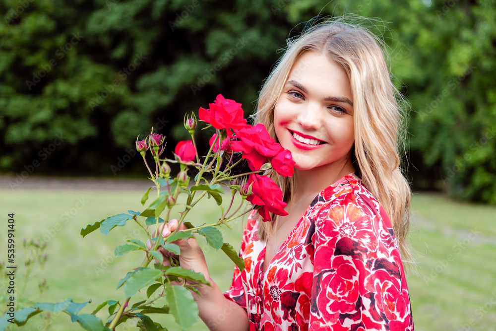 Naklejka premium Beautiful spring girl in fragrant pink flowers in summer blossom park Woman in a blooming garden as Fashion, Cosmetics and Perfumes With Blond Hair