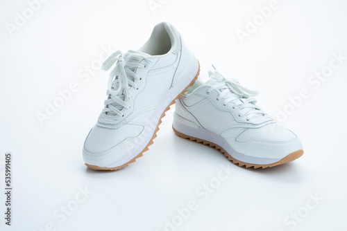 Pair of New Professional White Sneakers Over White Background.