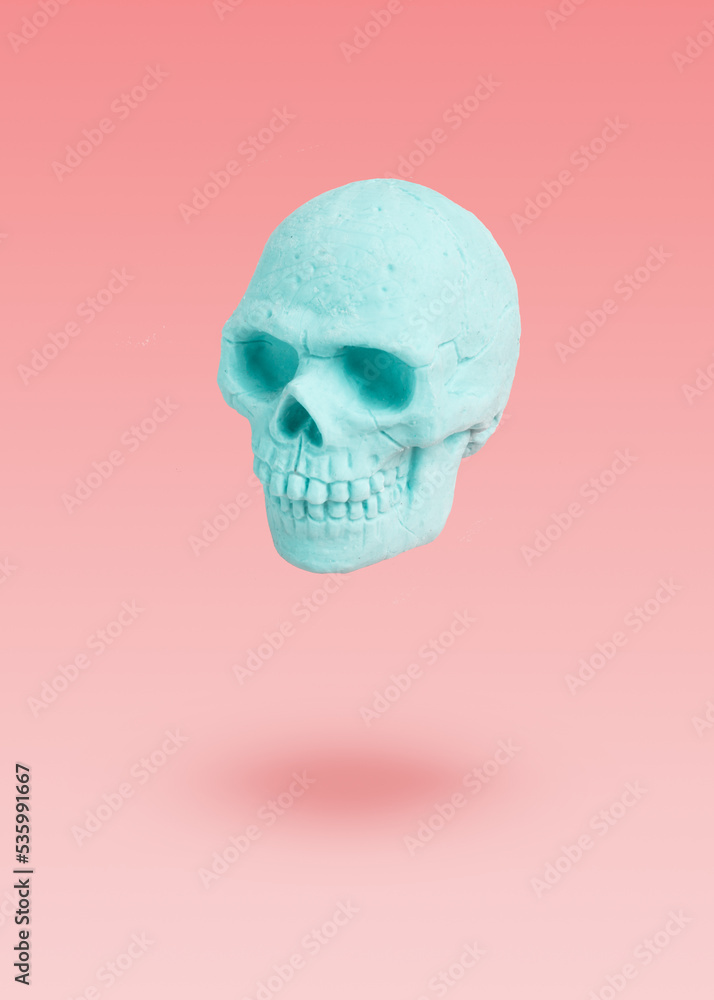 Mint skull levitation on a purple background. pastel concept Mint skull levitation on a purple background. pastel concept