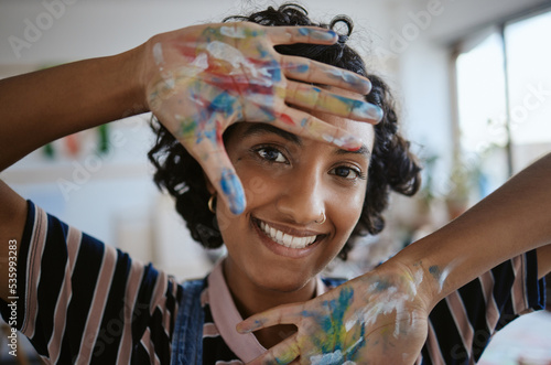 Creative portrait, woman hands with paint on happy art school student and oil painting inspiration for Indian girl. Fun learning color theory and young artist creativity in university workshop studio photo