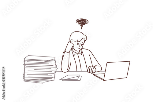 Distressed businessman overwhelmed with office work 
