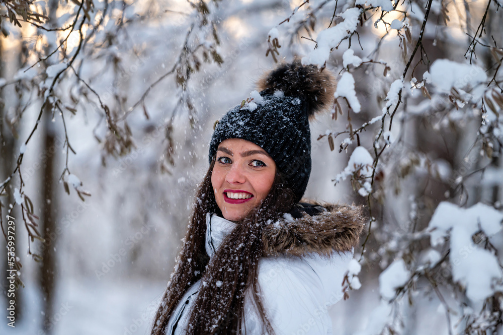young female walking in the snowy winter day outdoor, winter forest landscape background