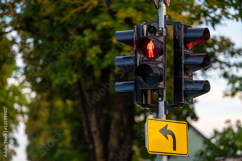 traffic semaphore with red pedestrian light on defocused urban background, closeup