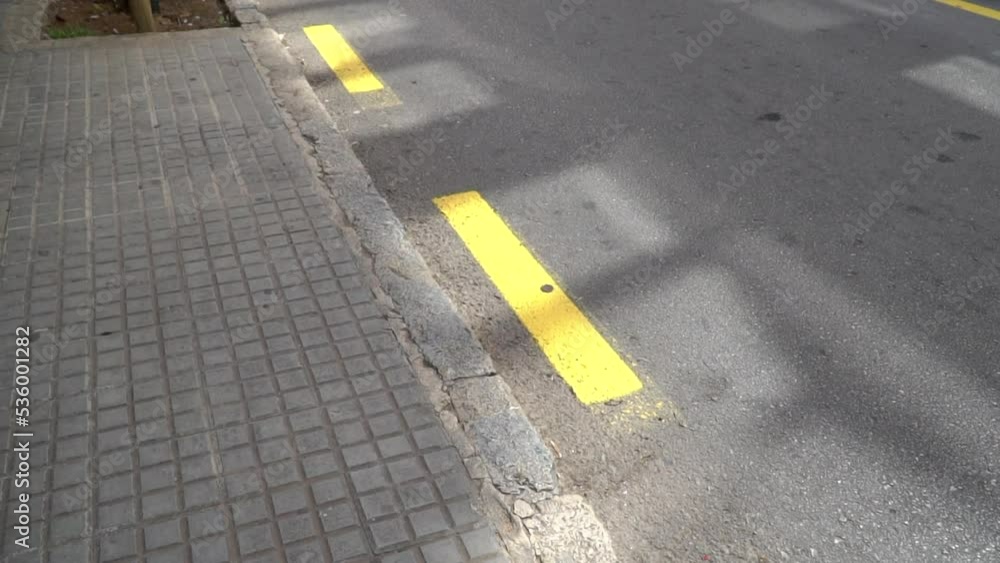Yellow dashed line on the asphalt road. Road markings. Asphalt dark
