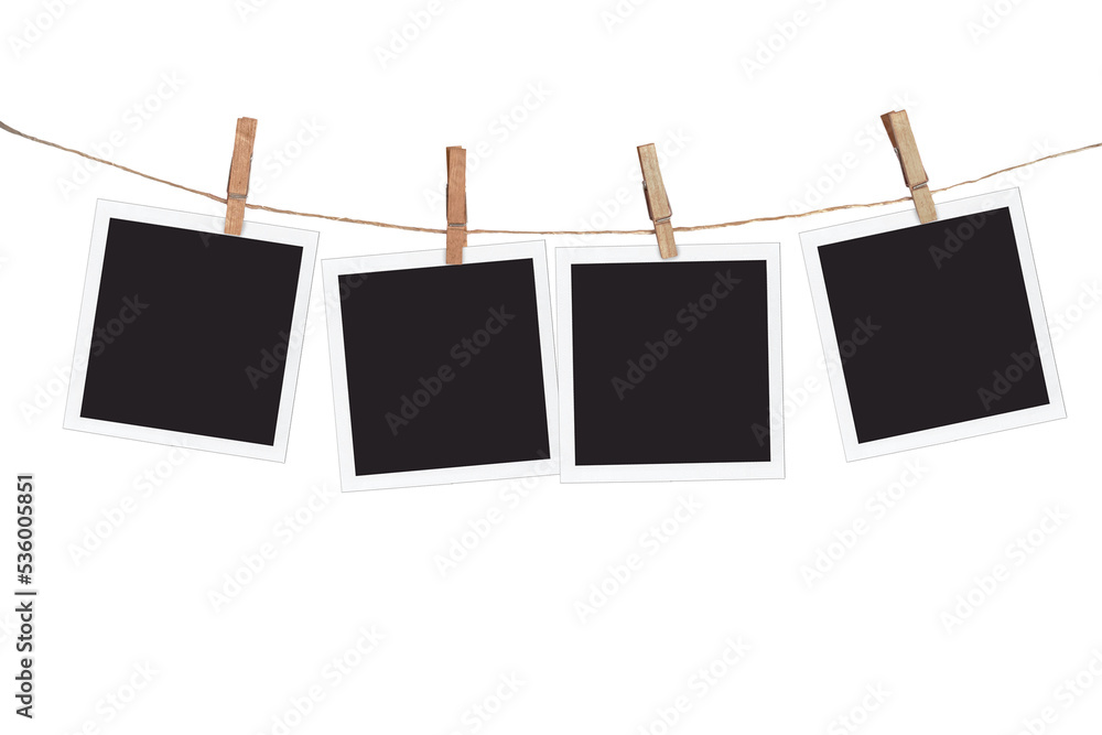 Four blank instant photo frames hanging on a rope, isolated on transparent background