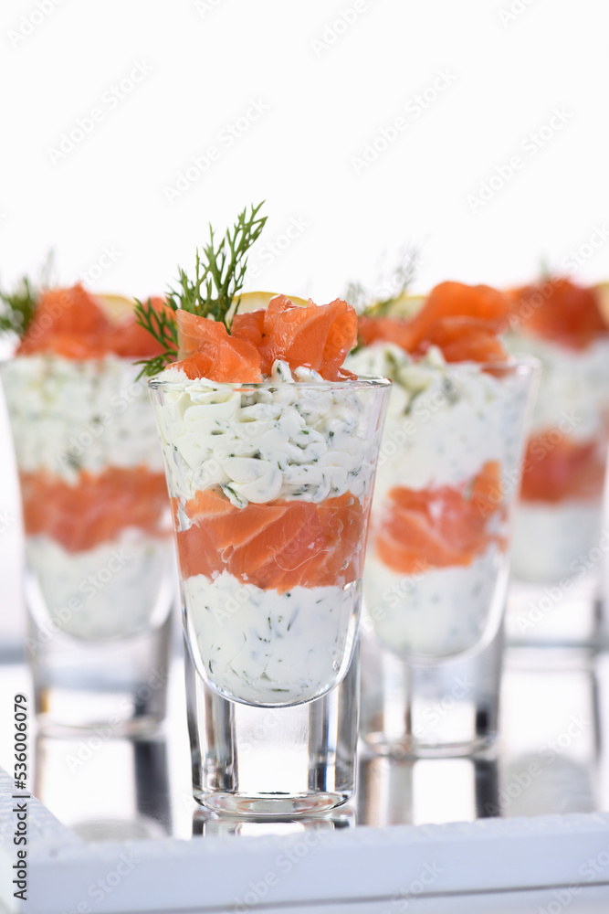 Verrine from soft cheese cream and salmon, dill sprig and lemon slice. Aperitif appetizer. Verrine from soft cheese cream and salmon, dill sprig and lemon slice. Aperitif appetizer.