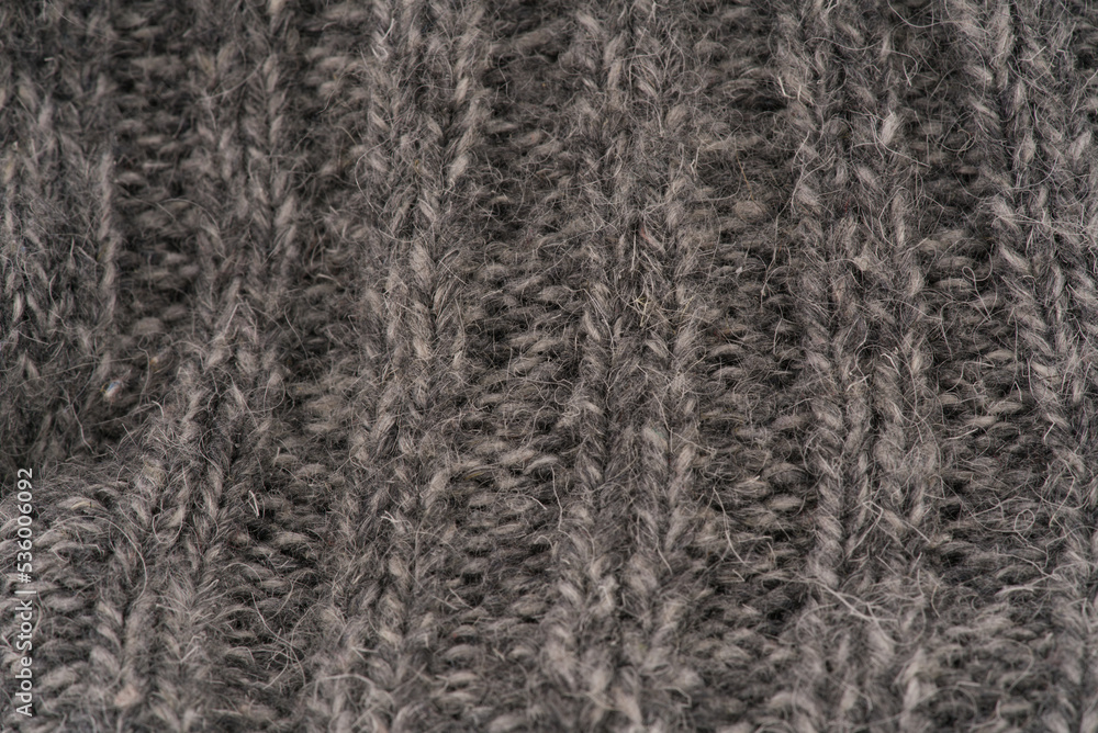 The texture of the wool closeup. Dark gray color. Vertical lines The texture of the wool closeup. Dark gray color. Vertical lines
