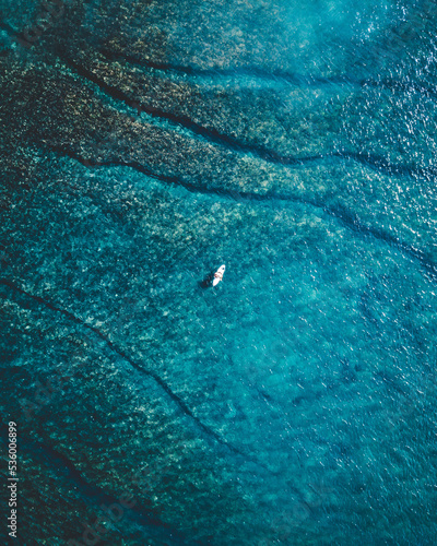 Topdown of a Surfer in the middle of the ocean