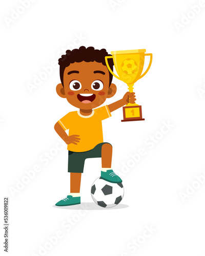 little kid win soccer competition and holding trophy