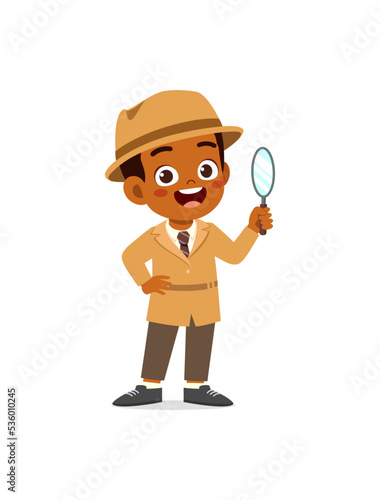 little kid wearing detective costume and holding magnifying glass