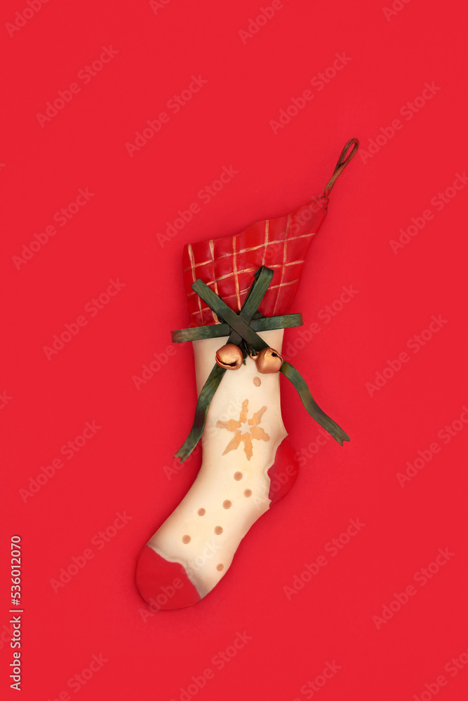 Christmas stocking tree ornament decoration vintage metal retro style on red background. Old fashioned symbol of Xmas Eve.