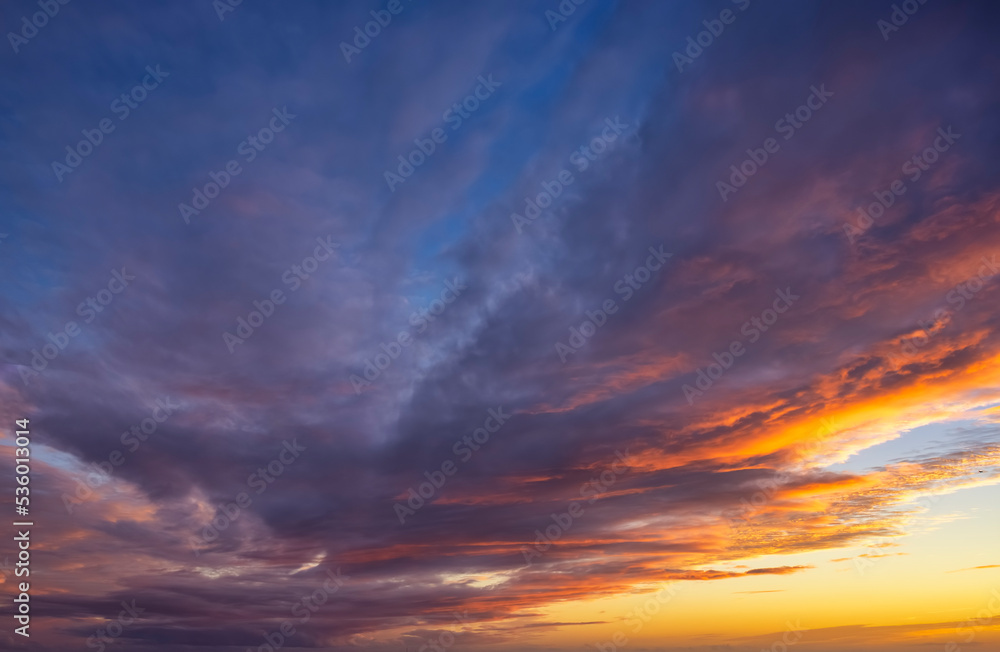 A vibrant sunset sky with orange, magenta and blue colors as a background or texture