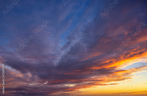 A vibrant sunset sky with orange, magenta and blue colors as a background or texture