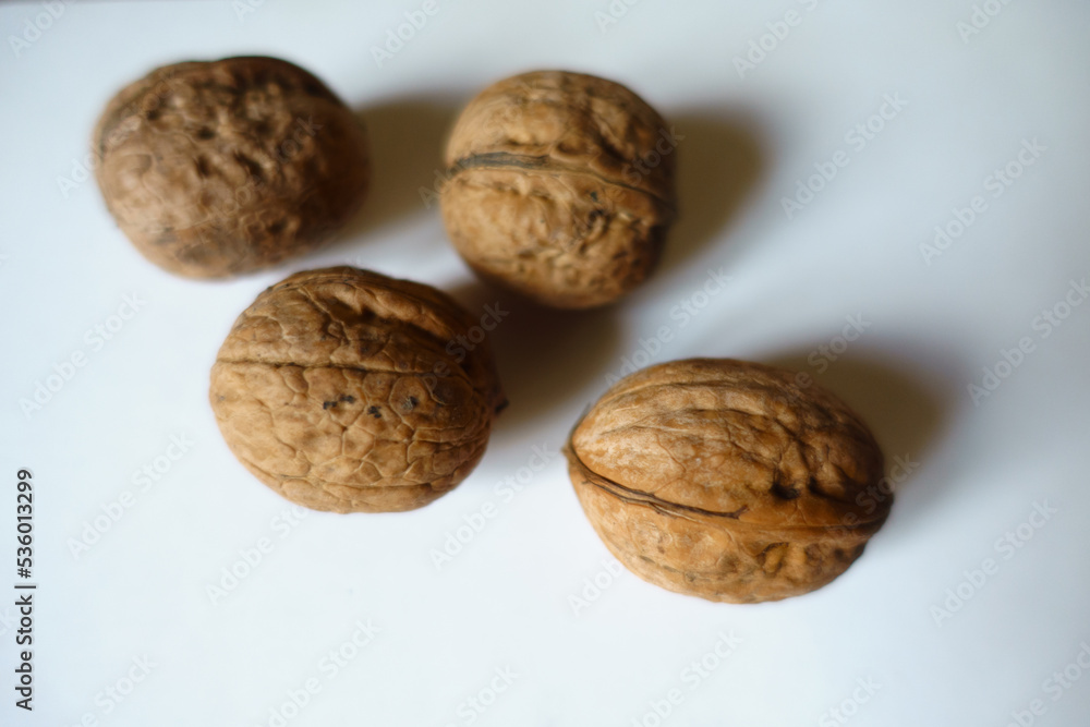 4 ripe brown rounded wrinkly fruits of Persian walnut 4 ripe brown rounded wrinkly fruits of Persian walnut