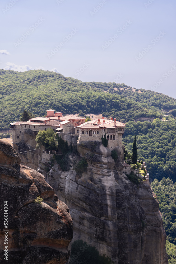Vertical shot of Holy Monastery Varlaam situated at top of a rocky precipice that is 373 meters above Pineios valley floor. Meteora, Greece