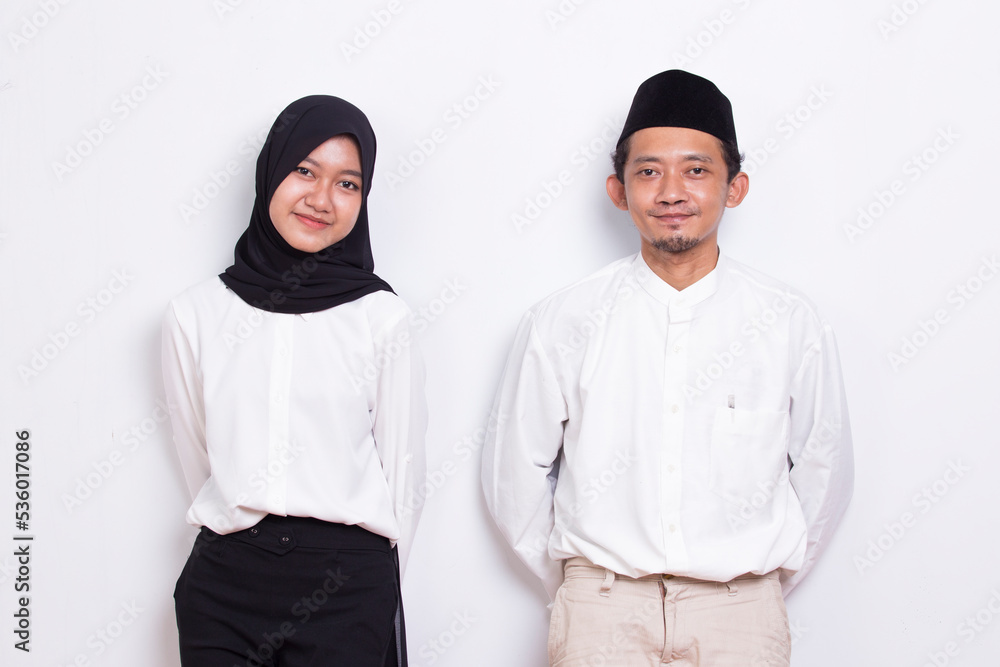 portrait young asian muslim couple welcoming guests and gretting portrait young asian muslim couple welcoming guests and gretting