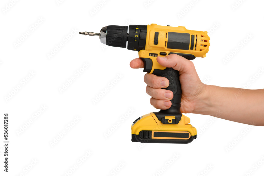 Cordless electric yellow screwdriver drill in hand isolated on white background. Close-up.