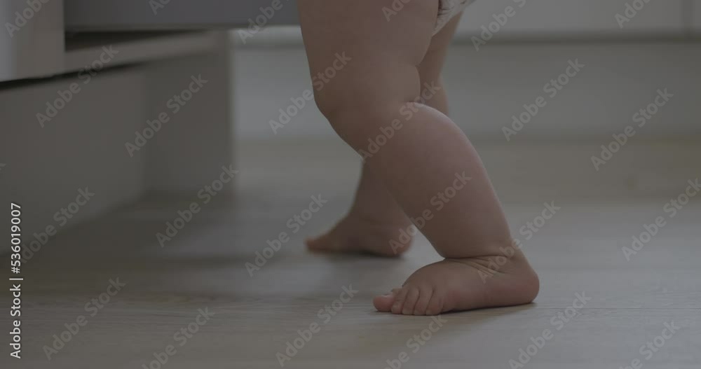 Handheld shot of shaky unstable baby feet Handheld shot of shaky unstable baby feet