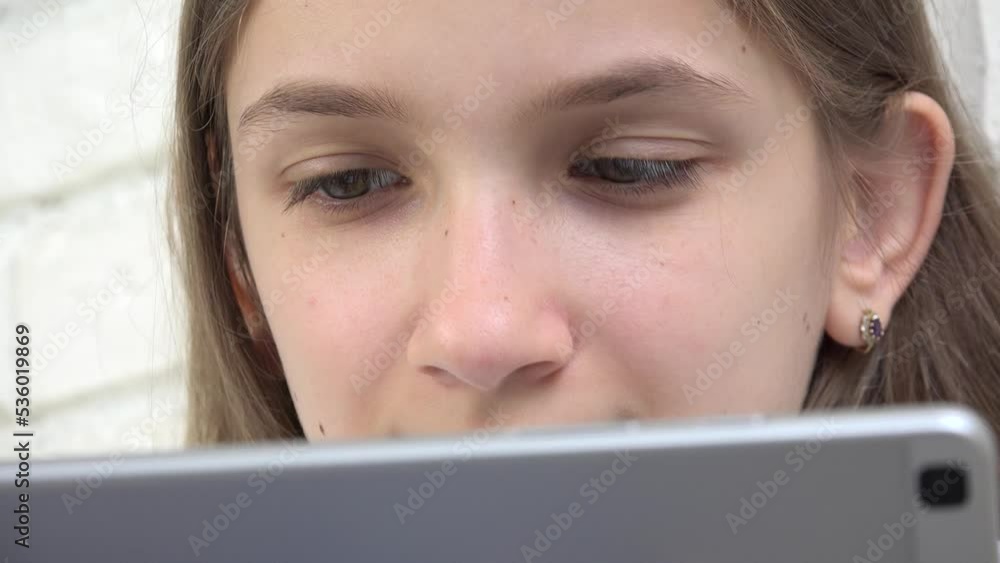 Child Playing Tablet Browsing Internet, Girl Using Smartphone, Young Kid Writing Reading Messages on Device, Online Gaming