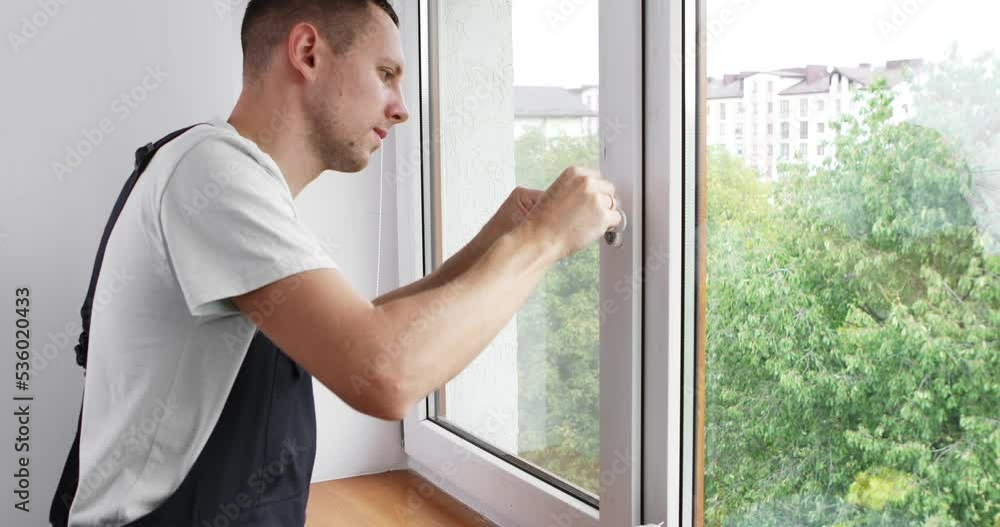 The worker installing and checking window in the house The worker installing and checking window in the house