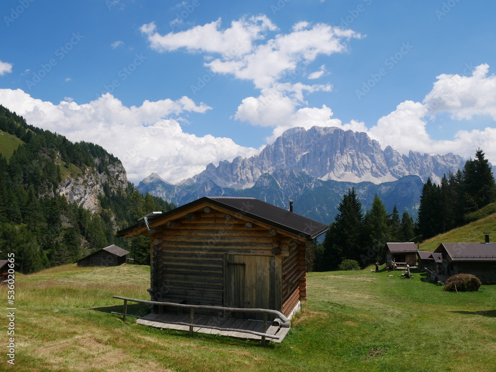 San Tomaso Agordino, Belluno, Italy: typical wooden mountain hut at Ciamp, San Tomaso Agordino. Mount Civetta, Dolomites, in the background San Tomaso Agordino, Belluno, Italy: typical wooden mountain hut at Ciamp, San Tomaso Agordino. Mount Civetta, Dolomites, in the background