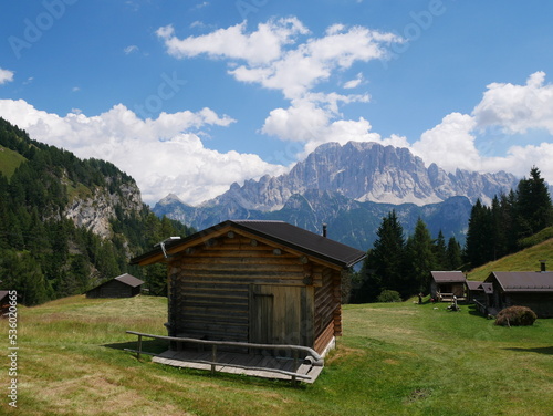 San Tomaso Agordino, Belluno, Italy: typical wooden mountain hut at Ciamp, San Tomaso Agordino. Mount Civetta, Dolomites, in the background 