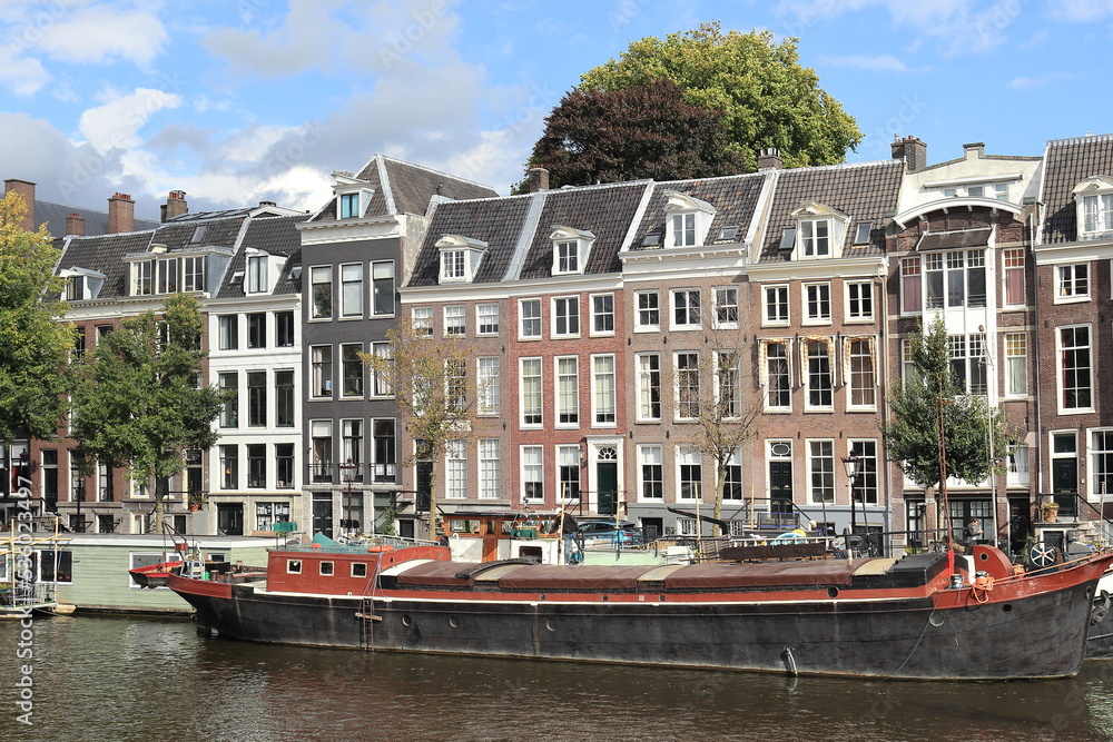 Amsterdam Amstel River View with Traditional Buildings and Boat, Netherlands