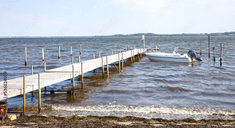 Fototapeta premium Seascape tranquil background with room for text, broken jetty