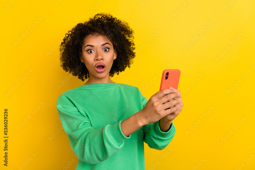 Photo of impressed confused lady hold telephone open mouth stare speechless isolated on yellow color background Photo of impressed confused lady hold telephone open mouth stare speechless isolated on yellow color background