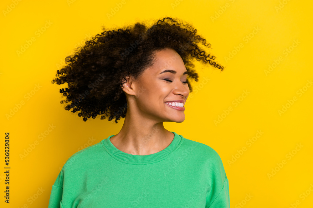Portrait of carefree cheerful girl closed eyes turn head throw hair isolated on yellow color background Portrait of carefree cheerful girl closed eyes turn head throw hair isolated on yellow color background