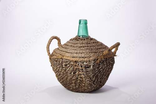 Antique demijohn on white background.