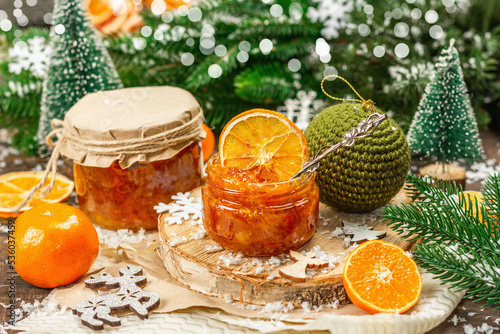 Orange marmalade or orange jam in glass jars. Sweet confiture with festive Christmas decor