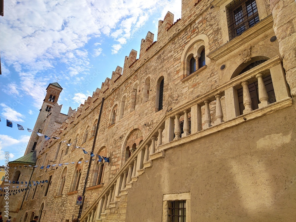 Trento, Trentino Alto Adige, Italy: low angle view of the Palazzo Pretorio, its battlements, mullioned windows and tower, in the old town of Trento 