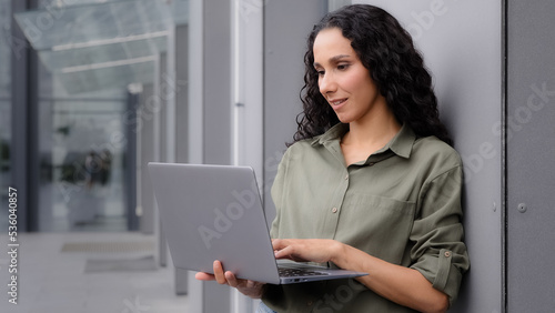 Closeup 30s woman user professional specialist worker manager freelancer businesswoman lady architect female business consultant student investor with laptop work online outdoors in city near building