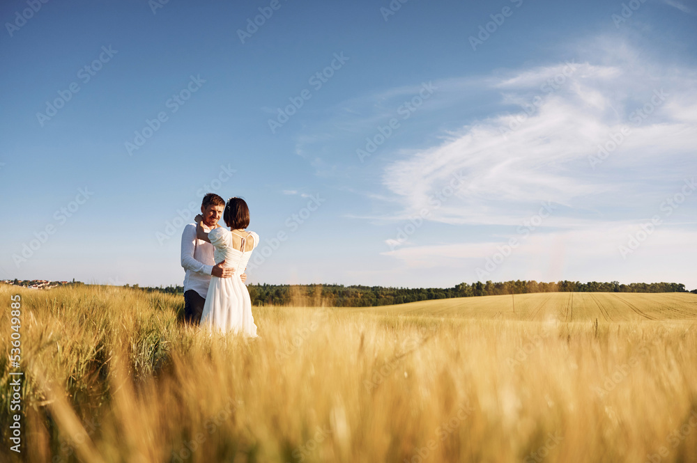 Conception of love. Couple just married. Together on the majestic agricultural field at sunny day Conception of love. Couple just married. Together on the majestic agricultural field at sunny day
