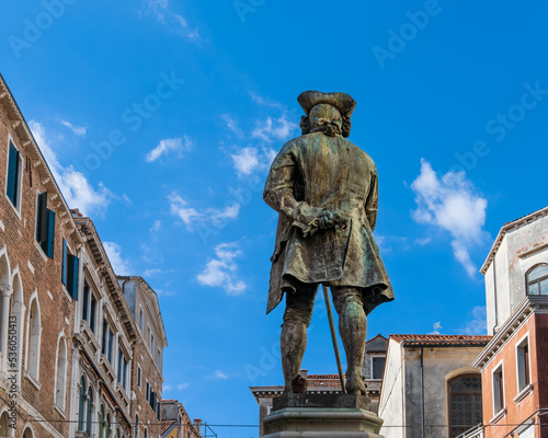 The monument to the Italian playwright and librettist Carlo Goldoni on Campo San Bartolomeo was erected in 1883 in the city of Venice, Italy. Monument to Goldoni with a walking stick on sunny morning