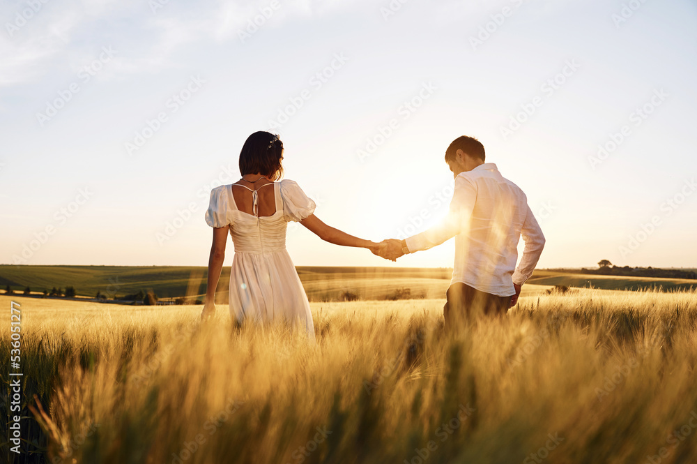 Against beautiful landscape. Couple just married. Together on the majestic agricultural field at sunny day Against beautiful landscape. Couple just married. Together on the majestic agricultural field at sunny day