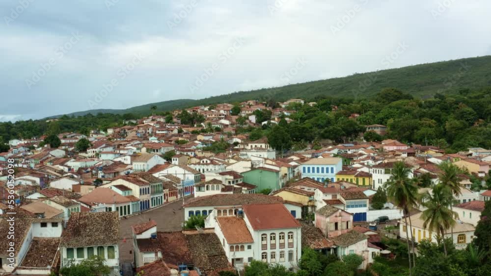 Rising aerial drone shot of the mountainous diamond-mining town of Lençóis in Bahia, eastern Brazil on a cloudy summer morning with small cobblestone streets and 19th-century buildings. Rising aerial drone shot of the mountainous diamond-mining town of Lençóis in Bahia, eastern Brazil on a cloudy summer morning with small cobblestone streets and 19th-century buildings.