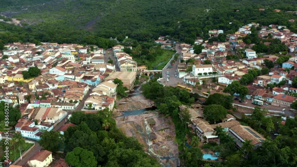 Wide rotating aerial drone shot of the mountainous diamond-mining town of Lençóis in Bahia, eastern Brazil on a cloudy summer morning with small cobblestone streets and 19th-century buildings. Wide rotating aerial drone shot of the mountainous diamond-mining town of Lençóis in Bahia, eastern Brazil on a cloudy summer morning with small cobblestone streets and 19th-century buildings.