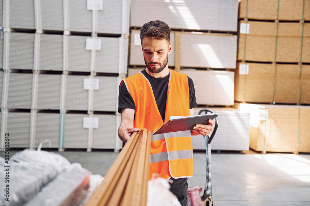 Checking quality of product. Storage worker is in the warehouse