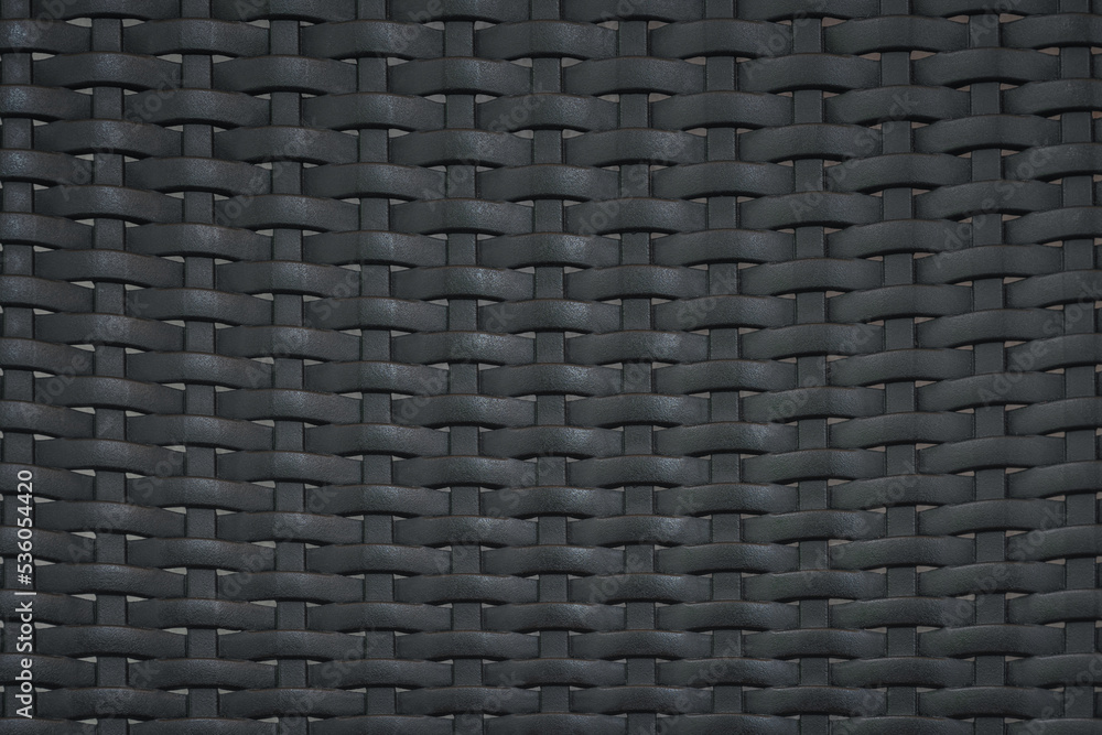 close up pattern of black plastic rattan modern furniture material background. for weave wallpaper backdrop design. close up pattern of black plastic rattan modern furniture material background. for weave wallpaper backdrop design.
