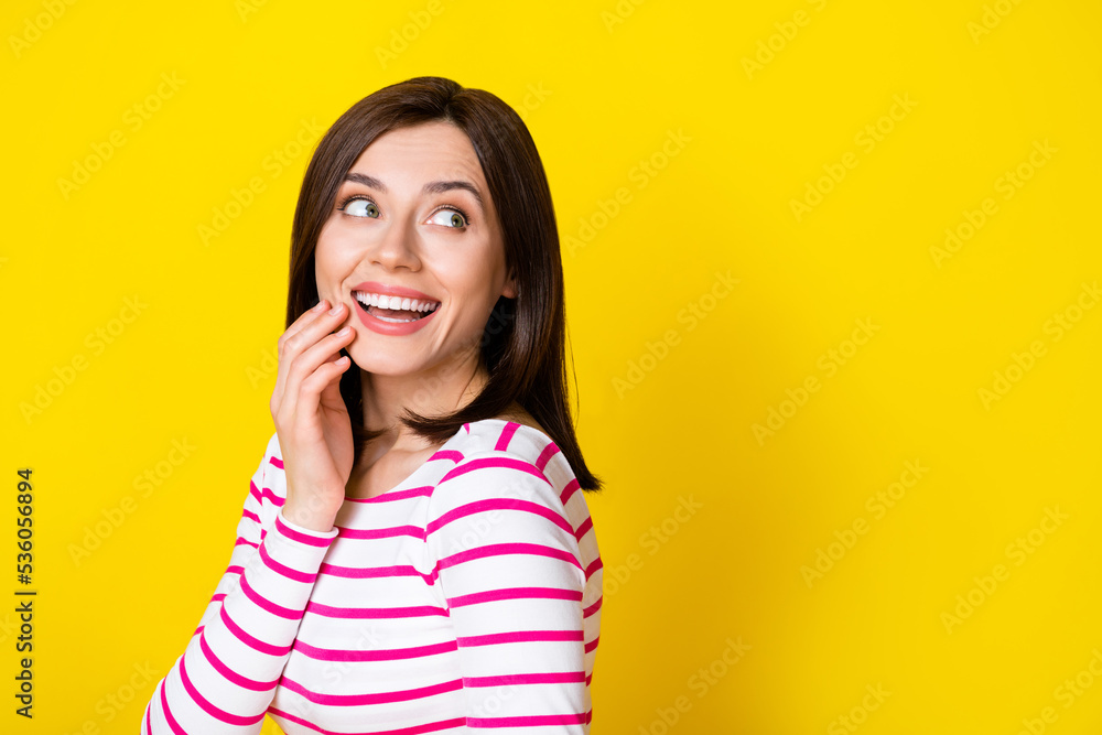Fototapeta premium Photo portrait of wondered dreamy young lady arm touch face look empty space wear stylish striped look isolated on yellow color background