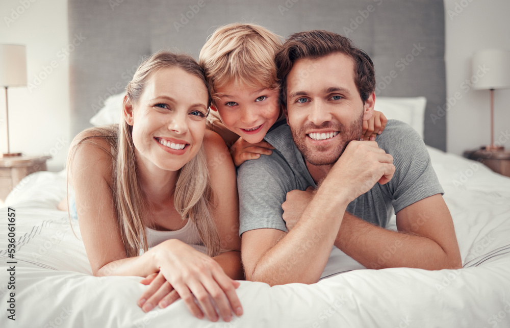Mother, father or boy bonding in bedroom at home, house or hotel in trust, love or safety. Family portrait, smile or happy man or woman and child, kid or son on relax security bed in Canada apartment