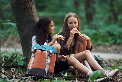 Slika na platnu Two girls is in the forest having a leisure activity, discovering new places