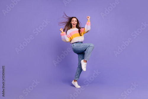 Full length photo of overjoyed delighted lady raise fists shout yes hooray luck isolated on violet color background