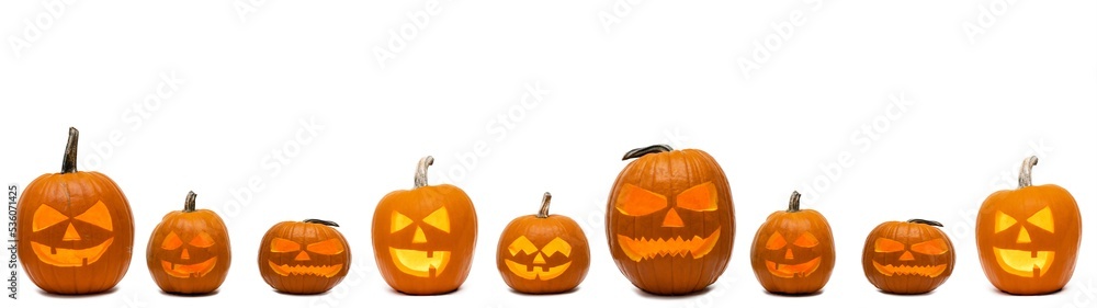 Halloween banner panorama long wide template - Many spooky scary carved glowing orange pumpkins, isolated on white background Halloween banner panorama long wide template - Many spooky scary carved glowing orange pumpkins, isolated on white background