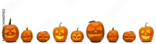 Halloween banner panorama long wide template - Many spooky scary carved glowing orange pumpkins, isolated on white background